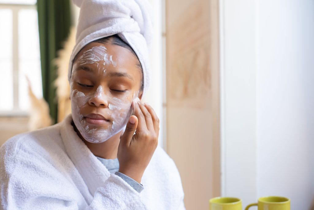 Daallu natural skincare products and botanical ingredients arranged in a minimalist apothecary setting
